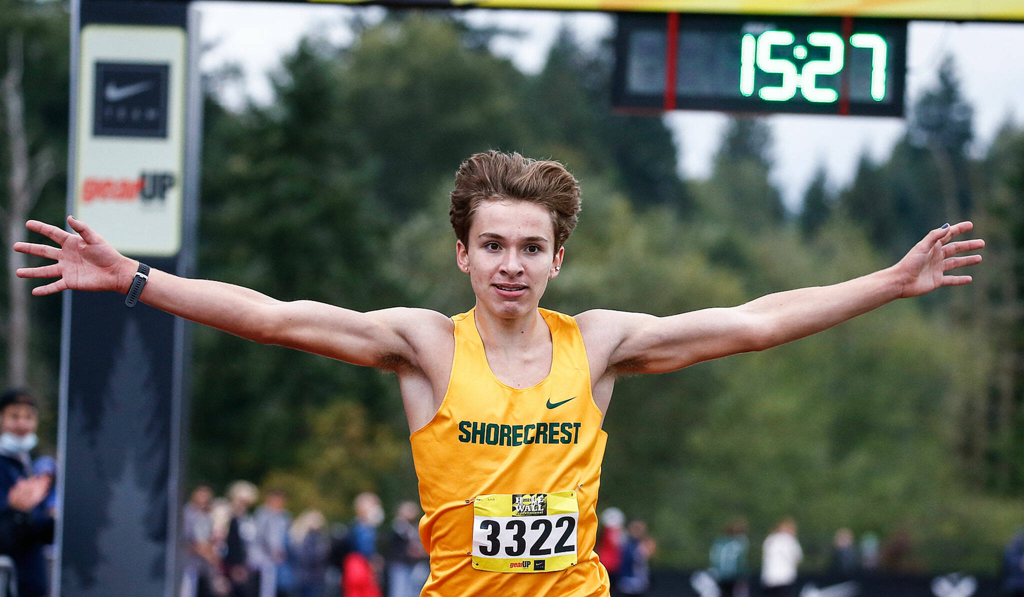 Shorecrest junior Luke Schmidt celebrates his victory in the boys gold division race at the Hole in the Wall Invitational on Saturday at Lakewood High School in Arlington. (Kevin Clark / The Herald)
