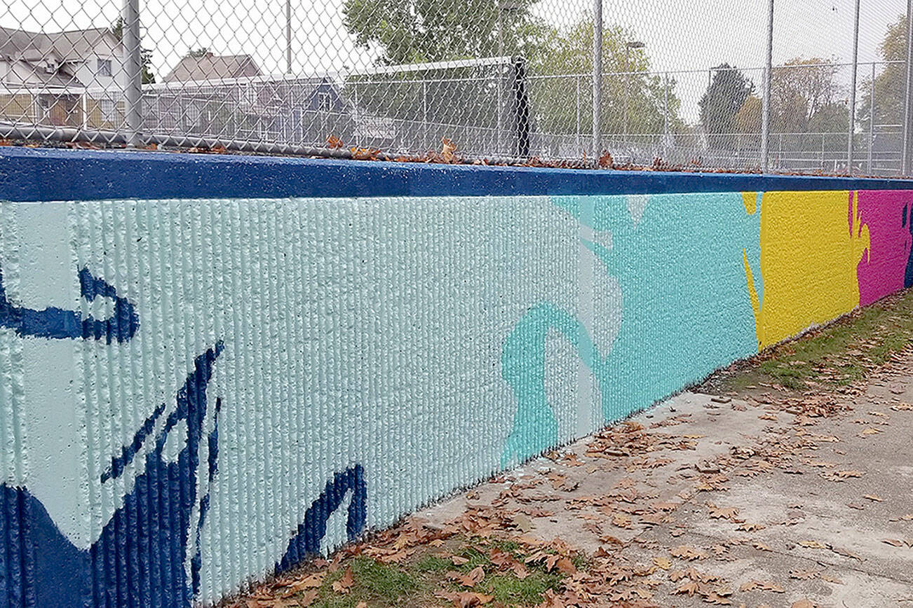 The concrete wall of the tennis courts at Clark Park in Everett was painted into a bright mural by people over two weekends. (Jay Austria)
