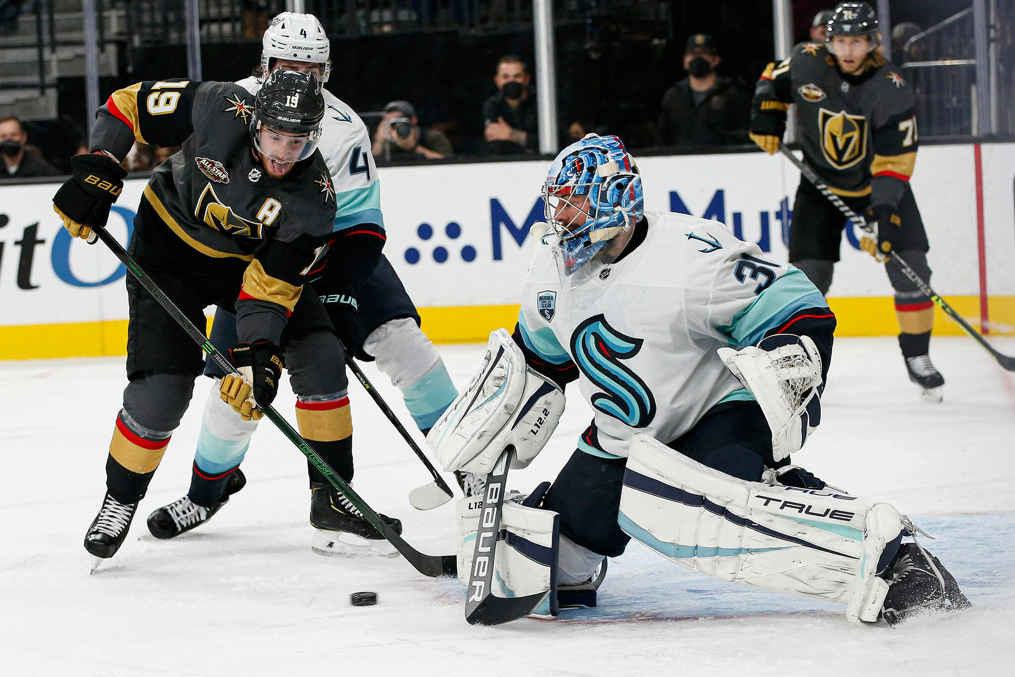 Kraken goaltender Philipp Grubauer (31) blocks the puck in front of Golden Knights right wing Reilly Smith (19) during the second period of a game Tuesday in Las Vegas. (AP Photo/Chase Stevens)