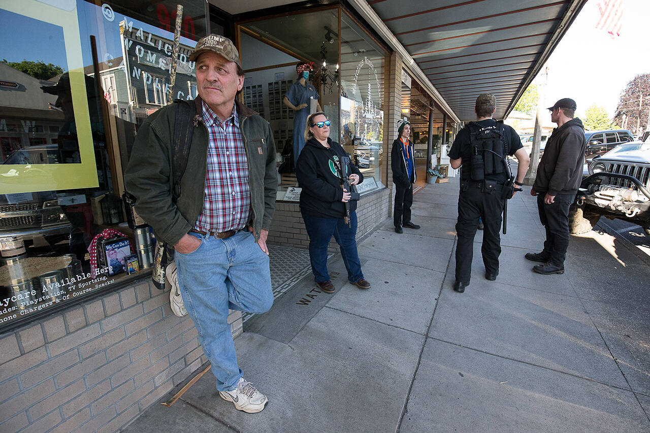 Armed citizens stand along First Street to protect businesses from possible looters during a June 2020 rally in Snohomish. (Andy Bronson / Herald file)