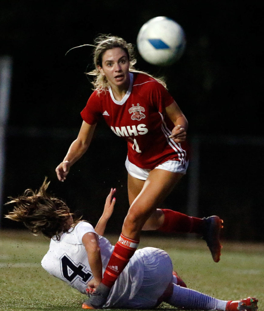 Archbishop Murphy’s Taylor Campbell (top) and Arlington’s Maddy Stivers battle for control of the ball during a game on Sept. 14, 2021, at Archbishop Murphy High School in Everett. The Wildcats won 6-1. (Kevin Clark / The Herald)

