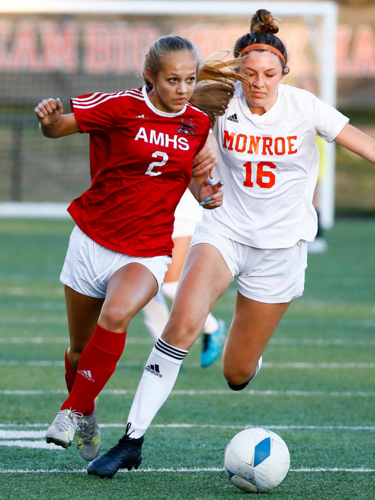 Archbishop Murphy’s Chloe McCoy controls the ball with Monroe’s Elle Greear trailing during a game on Sept. 23, 2021, at Archbishop Murphy High School in Everett. (Kevin Clark / The Herald)
