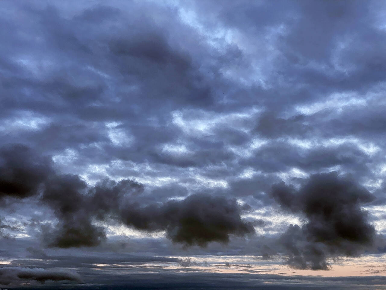 Clouds hover over the waters off Everett’s western edge Monday morning. (Sue Misao / The Herald)