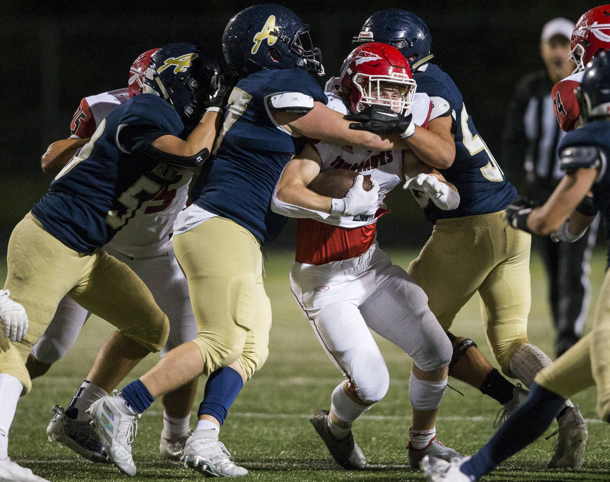 Arlington bottled up Dylan Carson and Marysville Pilchuck’s explosive rushing attack en route to a 28-14 upset of the 3A third-ranked Tomahawks in a pivotal Wesco 3A North showdown Friday night. (Olivia Vanni / The Herald)
