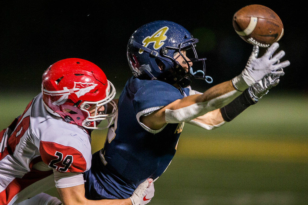 Arlington's Levi Younger reaches out for a pass during the game against Marysville-Pilchuck on Friday, Oct. 15, 2021 in Arlington, Wa. (Olivia Vanni / The Herald)