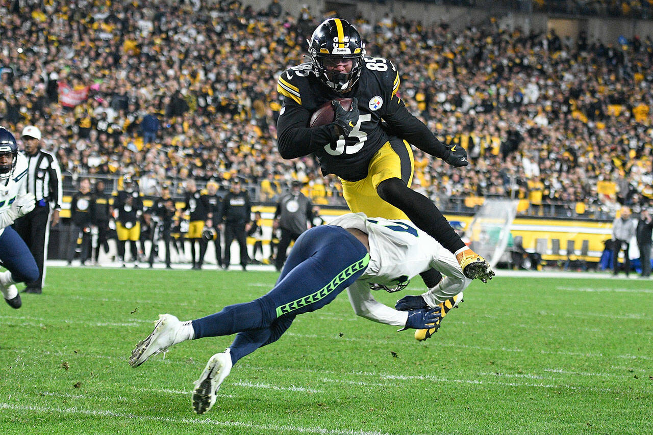 Pittsburgh Steelers tight end Eric Ebron (85) leaps over Seattle Seahawks defensive back Marquise Blair (27) on his way to a touchdown during the first half a game Sunday in Pittsburgh. (AP Photo/Don Wright)