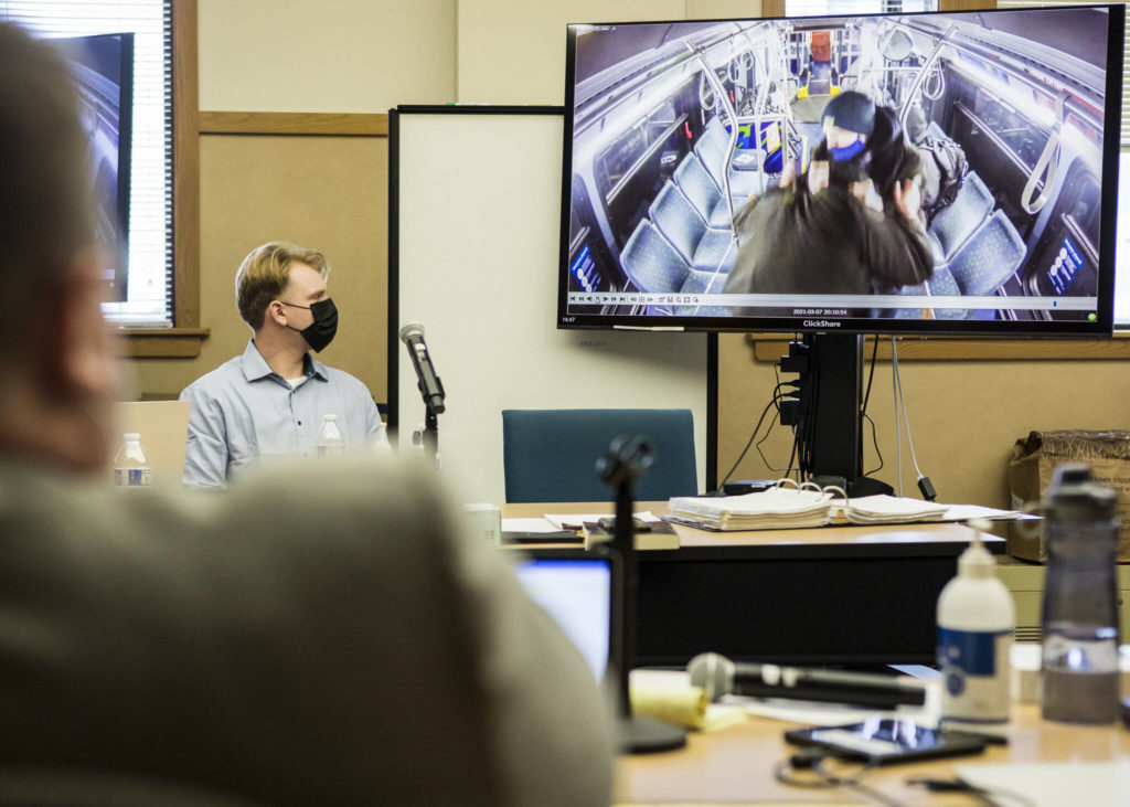 Alejandro Meza watches a video of the altercation he had with Gene Peterson on a Community Transit bus during opening statements of his trial Wednesday in Everett. (Olivia Vanni / The Herald)
