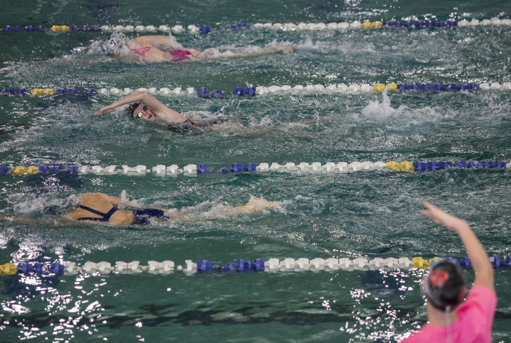 Snohomish’s Macky Blackwell takes a breath while a teammate cheers her on during the 200 Yard Freestyle on Tuesday, Oct. 19, 2021 in Snohomish, Wa. (Olivia Vanni / The Herald)
