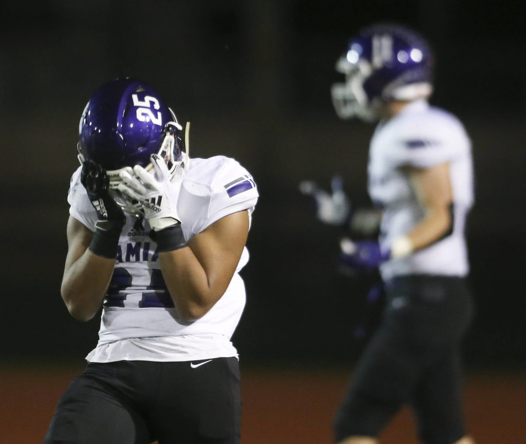Kamiak’s Jullian Notoa covers his face after fumbling the ball through the end zone for a touchback as Kamiak beat Mariner 41-14 in a football game at Goddard Stadium on Tuesday, Oct. 19, 2021 in Everett, Washington. (Andy Bronson / The Herald)
