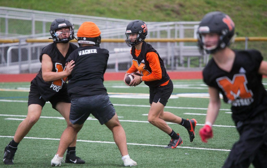 Leggett (center) said football provided a sense of normalcy for him after the fire. (Andy Bronson / The Herald)

