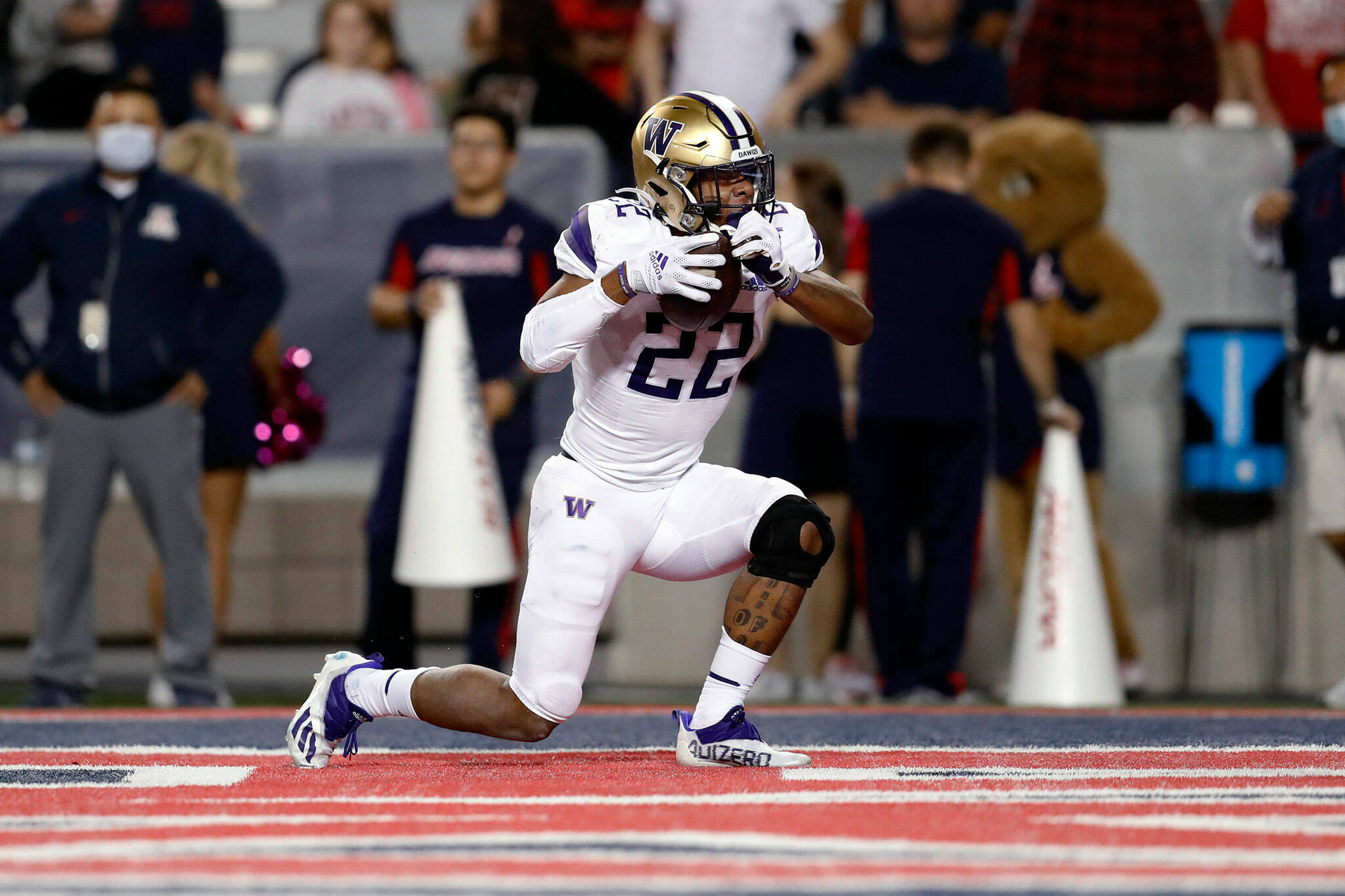 Washington running back Cameron Davis (22) reacts after scoring a touchdown during the second half of a game against Arizona on Friday in Tucson, Ariz. (AP Photo/Chris Coduto)