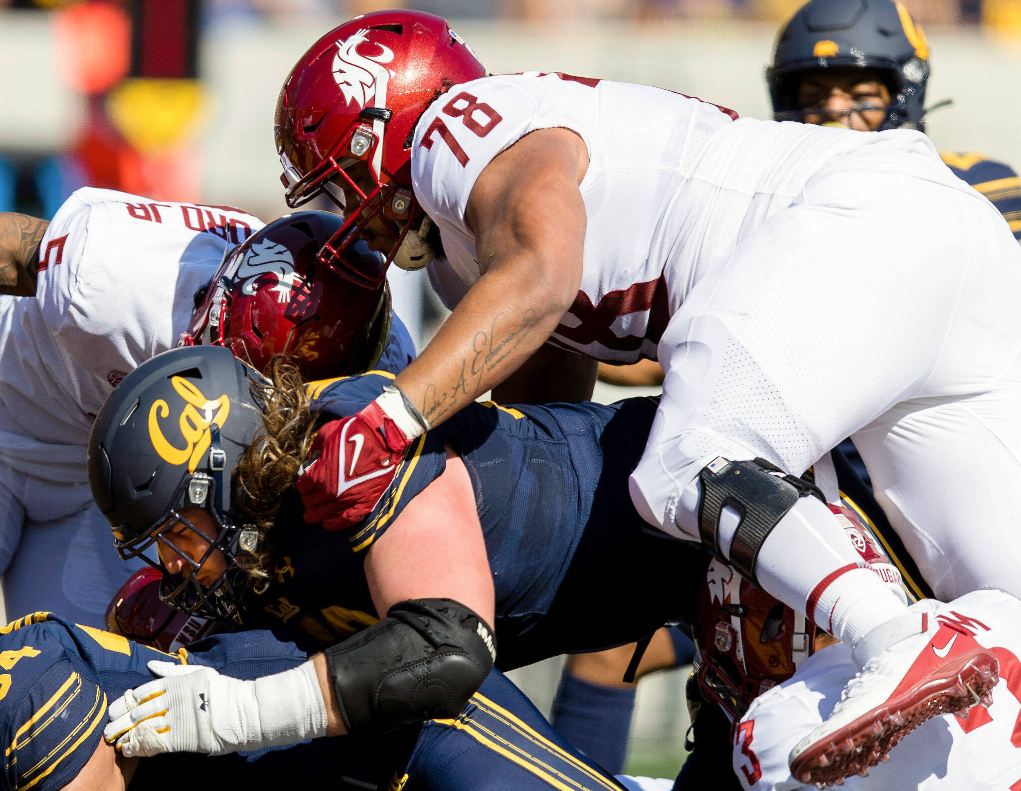Washington State defensive lineman Jesus Echevarria (78), an Archbishop Murphy alum, tackles California running back Christopher Brooks during a game on Oct. 2, 2021, in Berkeley, Calif. (AP Photo/John Hefti)