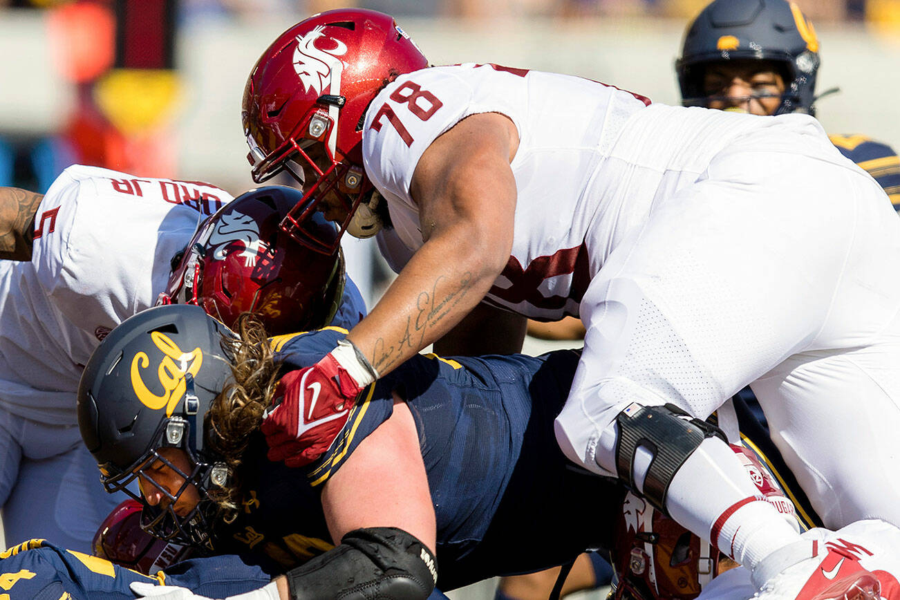 California running back Christopher Brooks (34) scores a touchdown as Washington State defensive lineman Jesus Echevarria (78) and others watch in the first quarter of an NCAA football game in Berkeley, Calif., Saturday, Oct. 2, 2021. (AP Photo/John Hefti)