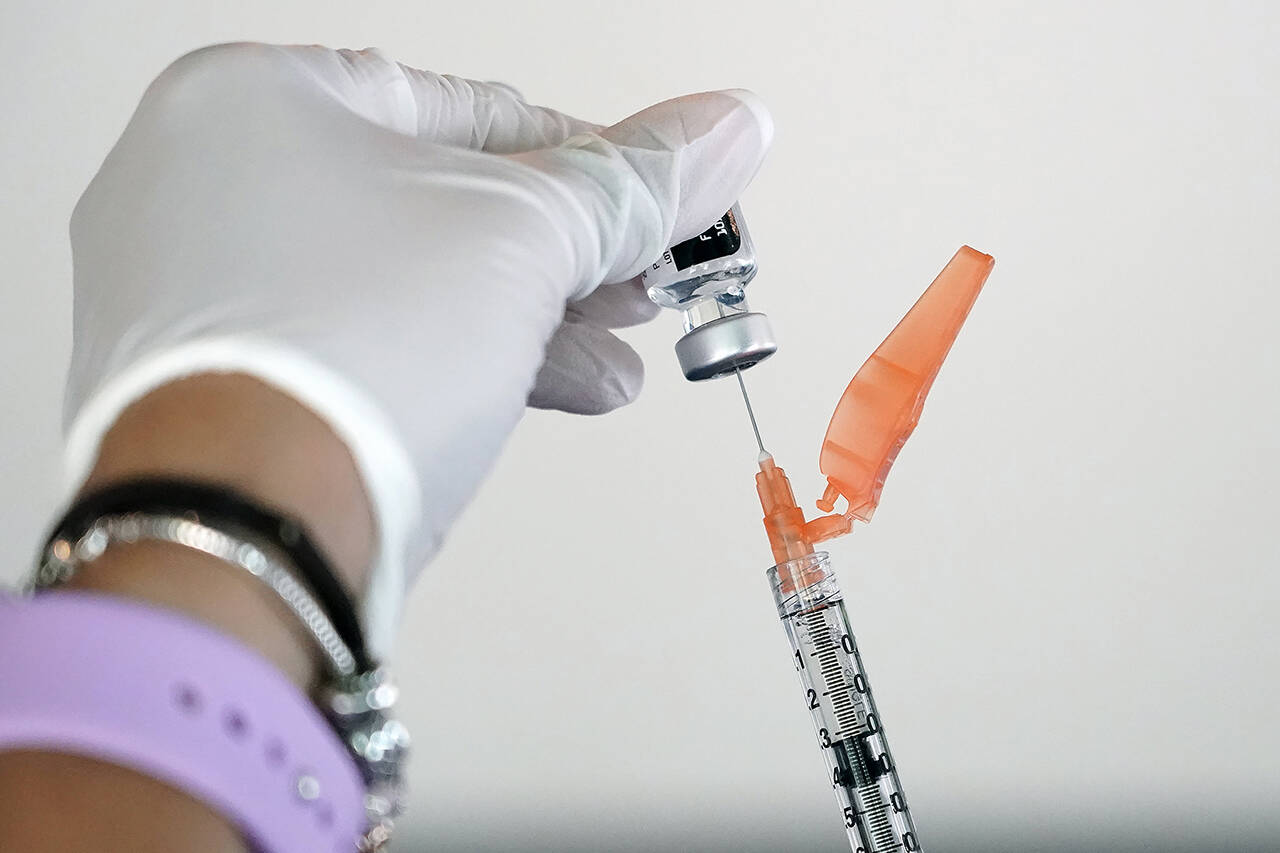 A nurse loads a syringe with the Pfizer covid-19 vaccine in Jackson, Miss., on Sept. 21. (Rogelio V. Solis / Associated Press)