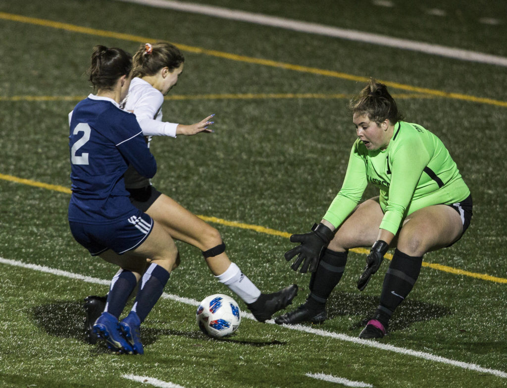 Jackson’s Abigail Harper comes out to stop a shot during the game Tuesday in Snohomish. (Olivia Vanni / The Herald)
