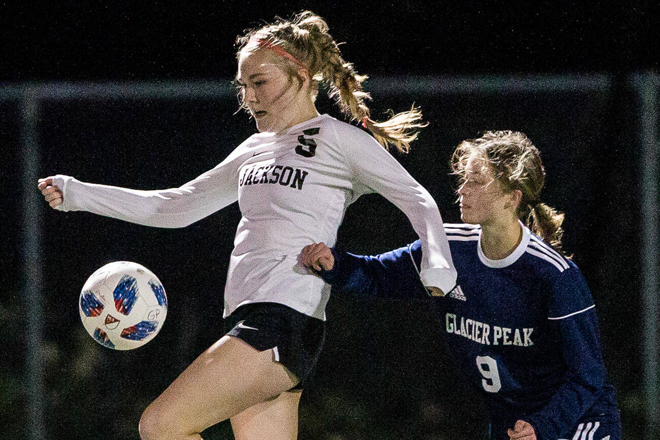 Jackson's Avery Friedricksen jumps to trap the ball during the game against Glacier Peak on Tuesday, Oct. 26, 2021 in Snohomish, Wa. (Olivia Vanni / The Herald)