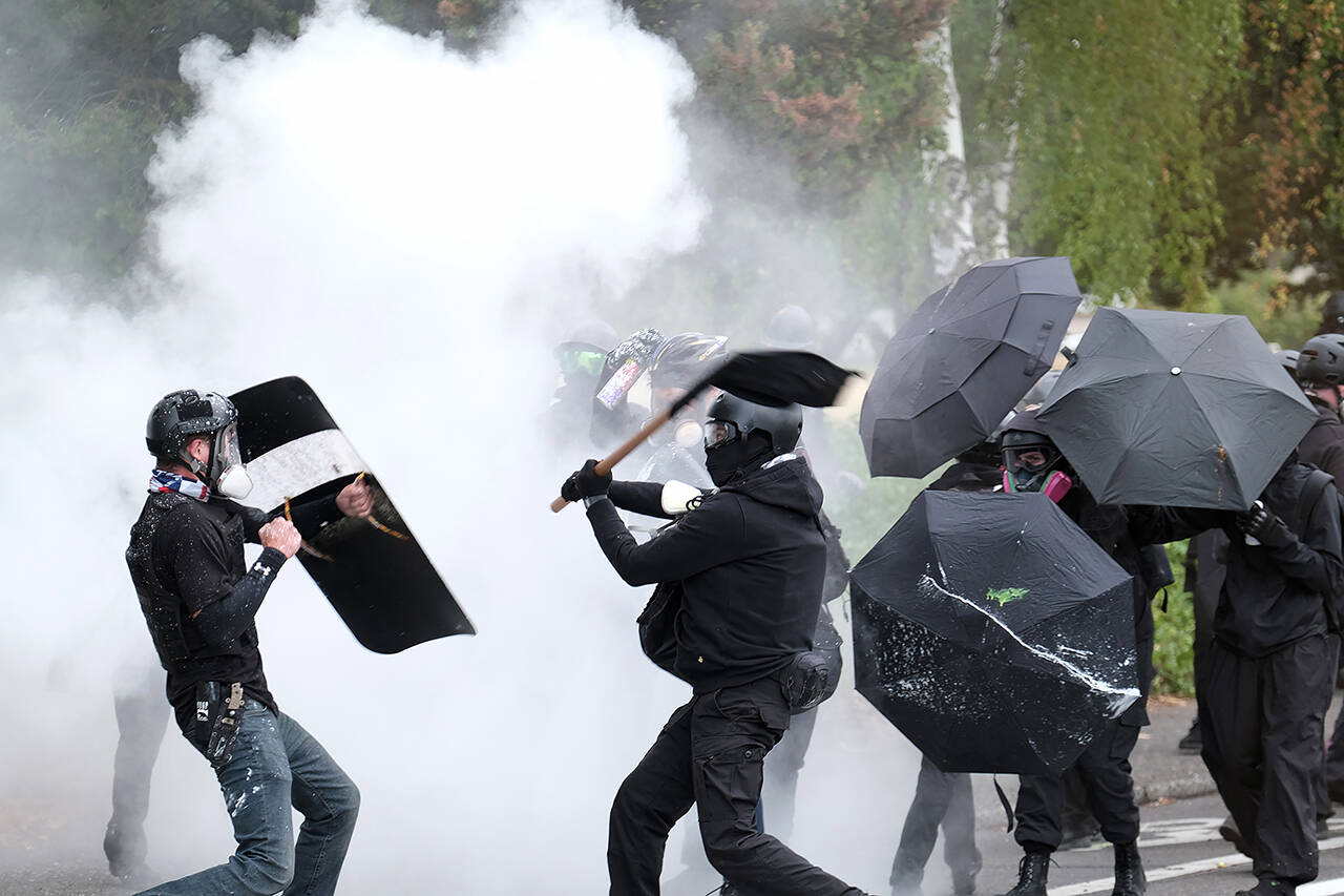 An anti-fascist protester and a member of the far-right Proud Boys clash during a demonstration Aug. 22 in Portland, Oregon. The city’s leaders were told this week that Portland’s “badly damaged” reputation continues to hurt the standing of Oregon’s largest city in the eyes of potential visitors. (AP Photo/Alex Milan Tracy, File)