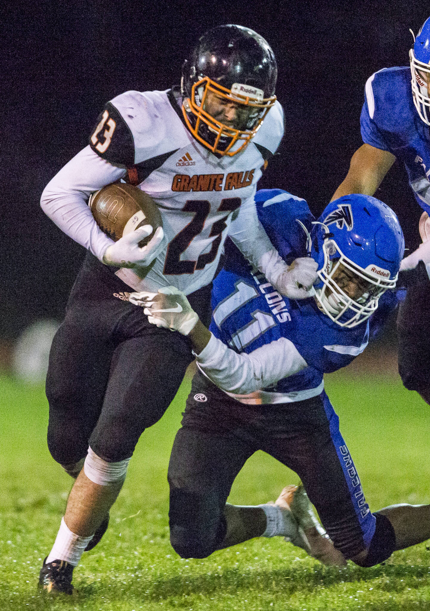 Granite Falls’ Gio Gonzalez grabs the face mask of South Whidbey’s Prince Browne as he tries to escape a tackle during the game on Friday, Oct. 29, 2021 in Langley, Wa. (Olivia Vanni / The Herald)