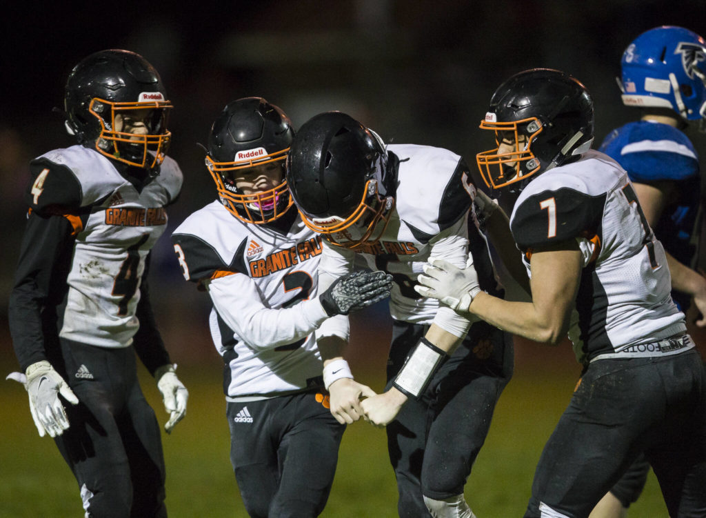 Granite Falls’ Riley Hoople celebrates his touchdown with his teammates during the game against South Whidbey on Friday, Oct. 29, 2021 in Langley, Wa. (Olivia Vanni / The Herald)
