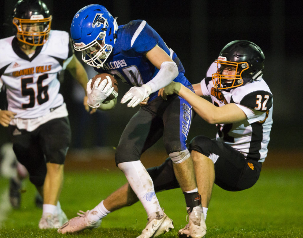 Granite Falls’ Gavin Toland tackles South Whidbey’s Erik Haugen during the game on Friday, Oct. 29, 2021 in Langley, Wa. (Olivia Vanni / The Herald)
