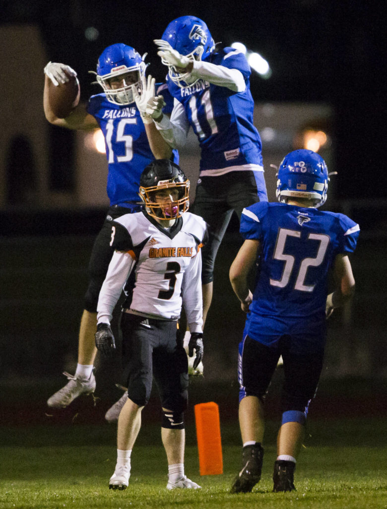 South Whidbey’s Lucas Taksony and Prince Browne celebrate a touchdown during the game against Granite Falls on Friday, Oct. 29, 2021 in Langley, Wa. (Olivia Vanni / The Herald)
