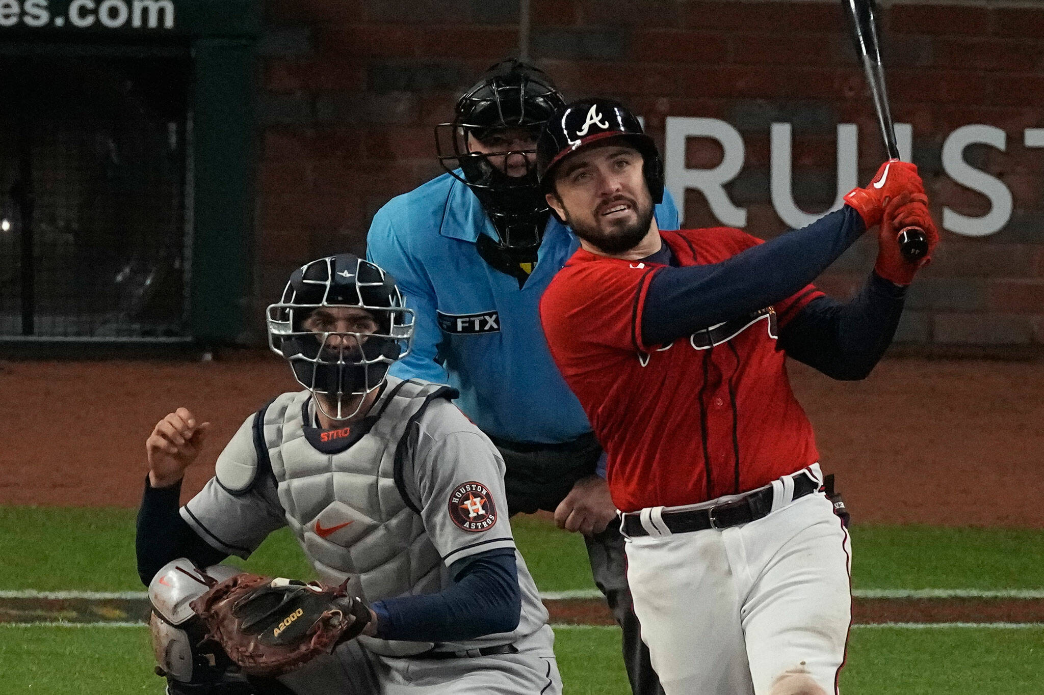 The Braves’ Travis d’Arnaud watches his home run during the eighth inning of Game 3 of the World Series against the Astros on Oct. 29, 2021, in Atlanta. (AP Photo/John Bazemore)