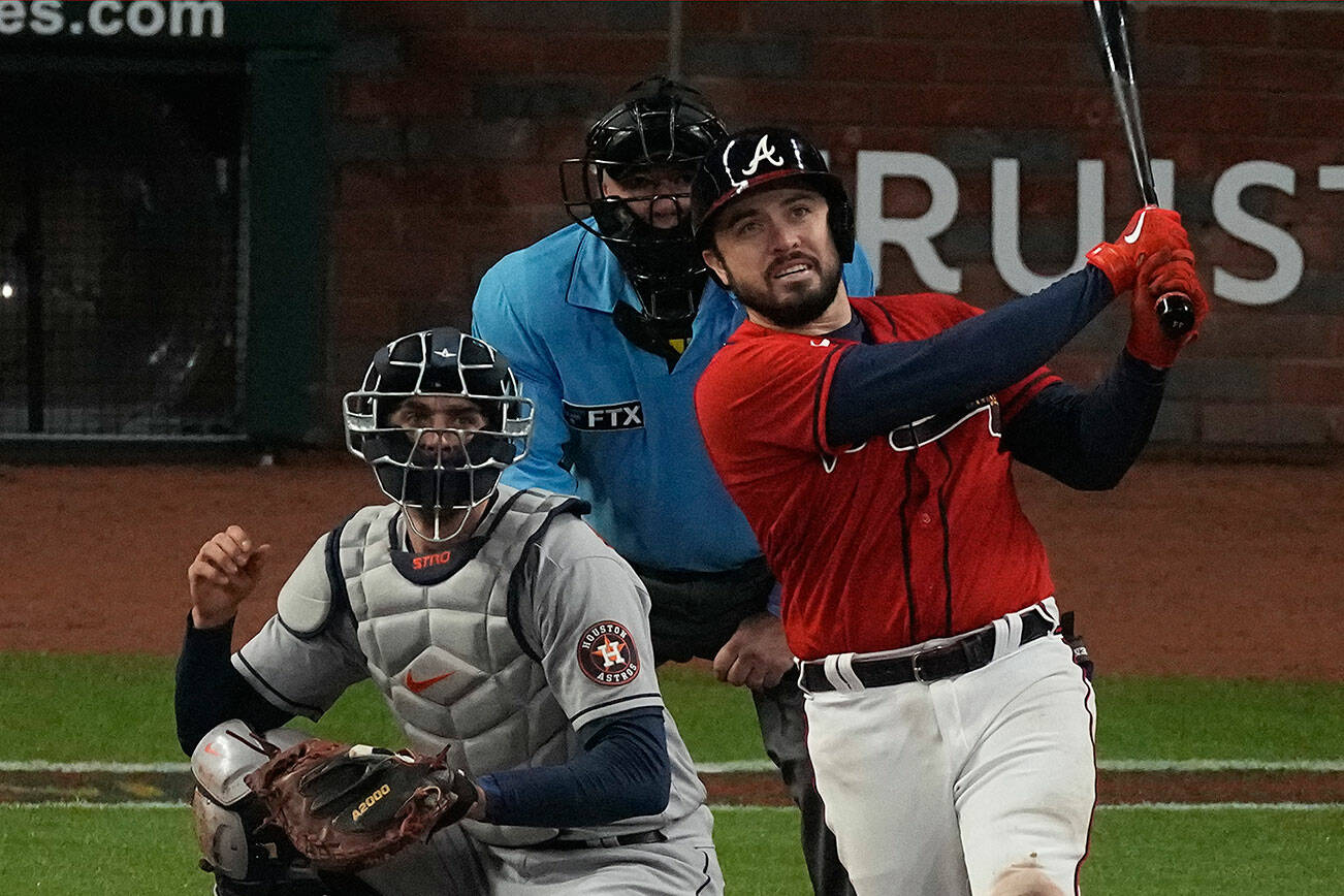 Atlanta Braves' Travis d'Arnaud watches his home run during the eighth inning in Game 3 of baseball's World Series between the Houston Astros and the Atlanta Braves Friday, Oct. 29, 2021, in Atlanta. (AP Photo/John Bazemore)