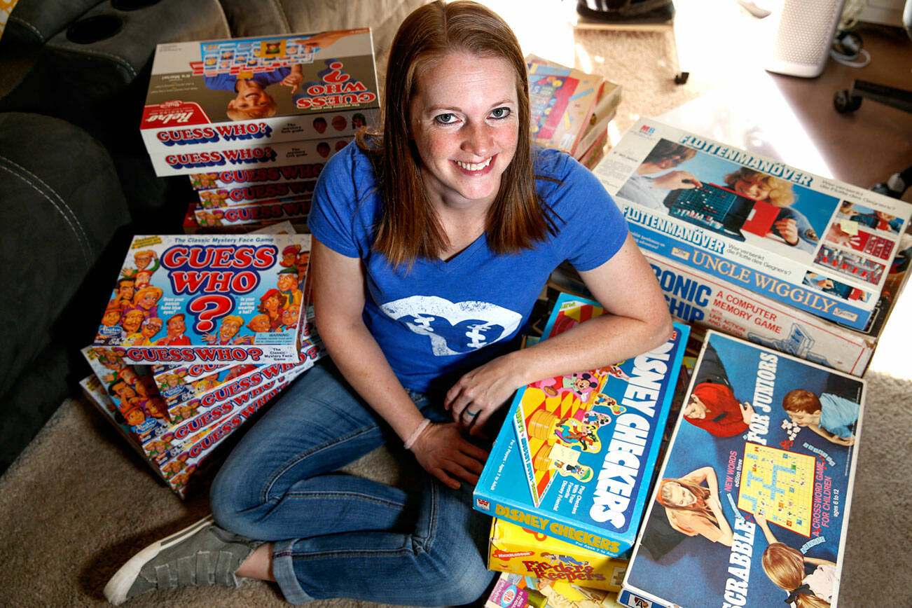 Bonnie "Boardgame Bonnie" Hertzog buys and sells vintage board games online from her one-bedroom apartment in Everett on September 24, 2021. (Kevin Clark / The Herald)