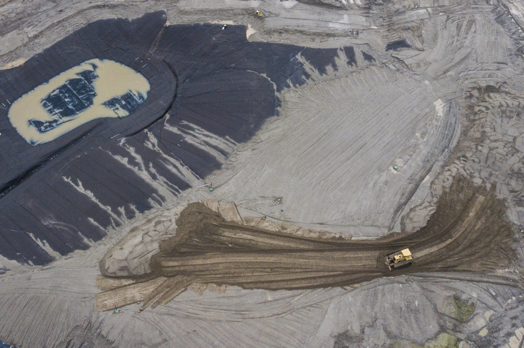A bulldozer drives through the former Go East Corp. landfill construction zone in Everett. (Olivia Vanni / The Herald)
