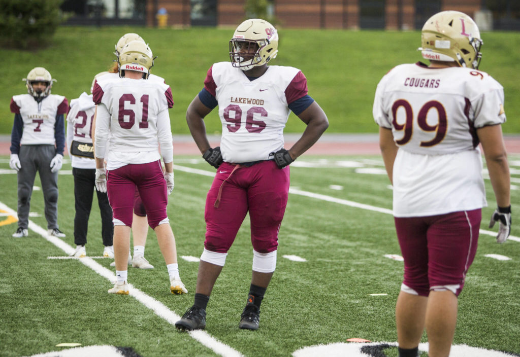 Jakobus Seth and his teammates warm up before the start of practice at Lakewood High School on Oct. 26 in Arlington. (Olivia Vanni / The Herald)
