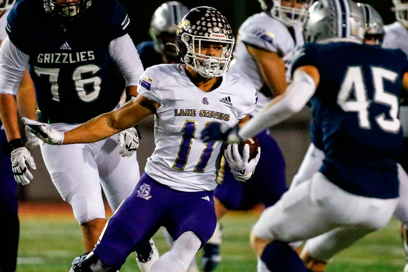 Lake Stevens' Gavin Steidle rushes with Glacier Peak's Rider Wilkinson closing at Veterans Memorial Stadium Friday night in Snohomish on October 29, 2021. (Kevin Clark / The Herald)