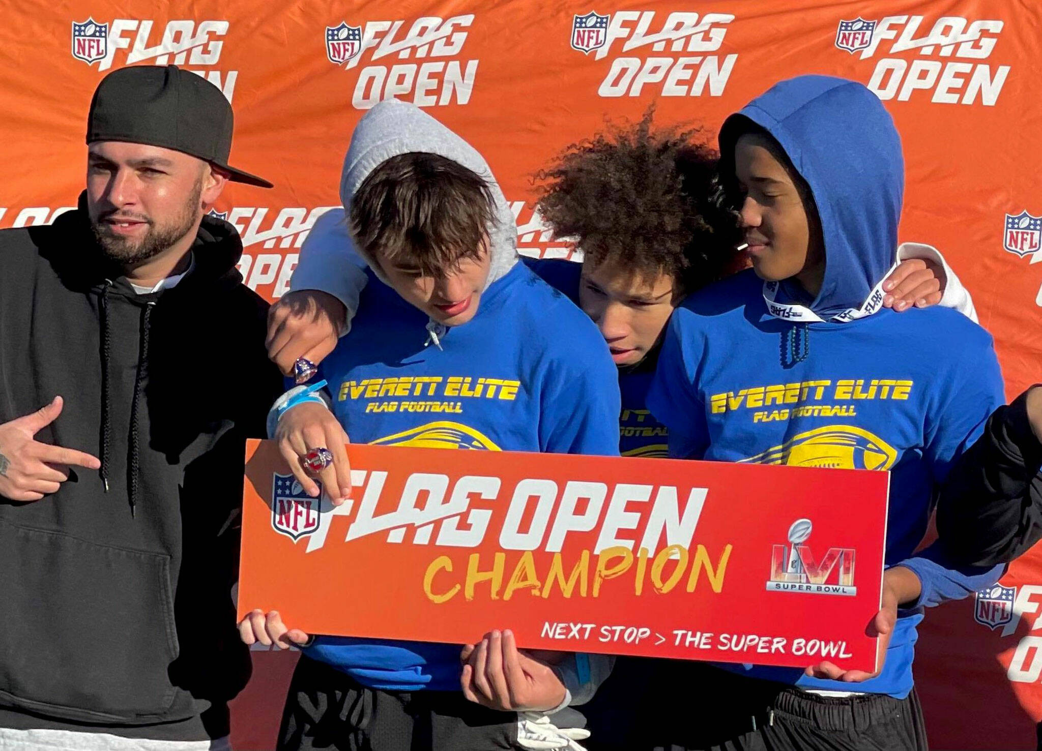 Members of the Everett Elite Flag Football 14-under team hold up a sign after winning the NFL FLAG open regional championship on Oct. 30, 2021, in Tacoma. (Photo provided by Jacob Hiatt)