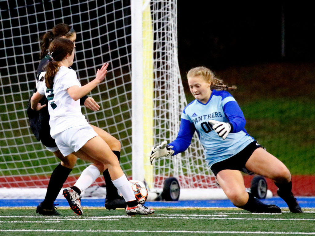 Snohomish’s Catherine Greene stops a shot at goal by Edmonds-Woodway’s Kate Baldock with Snohomish’s Sophia Andre defending Tuesday night at Shoreline Stadium on November 2, 2021. (Kevin Clark / The Herald)
