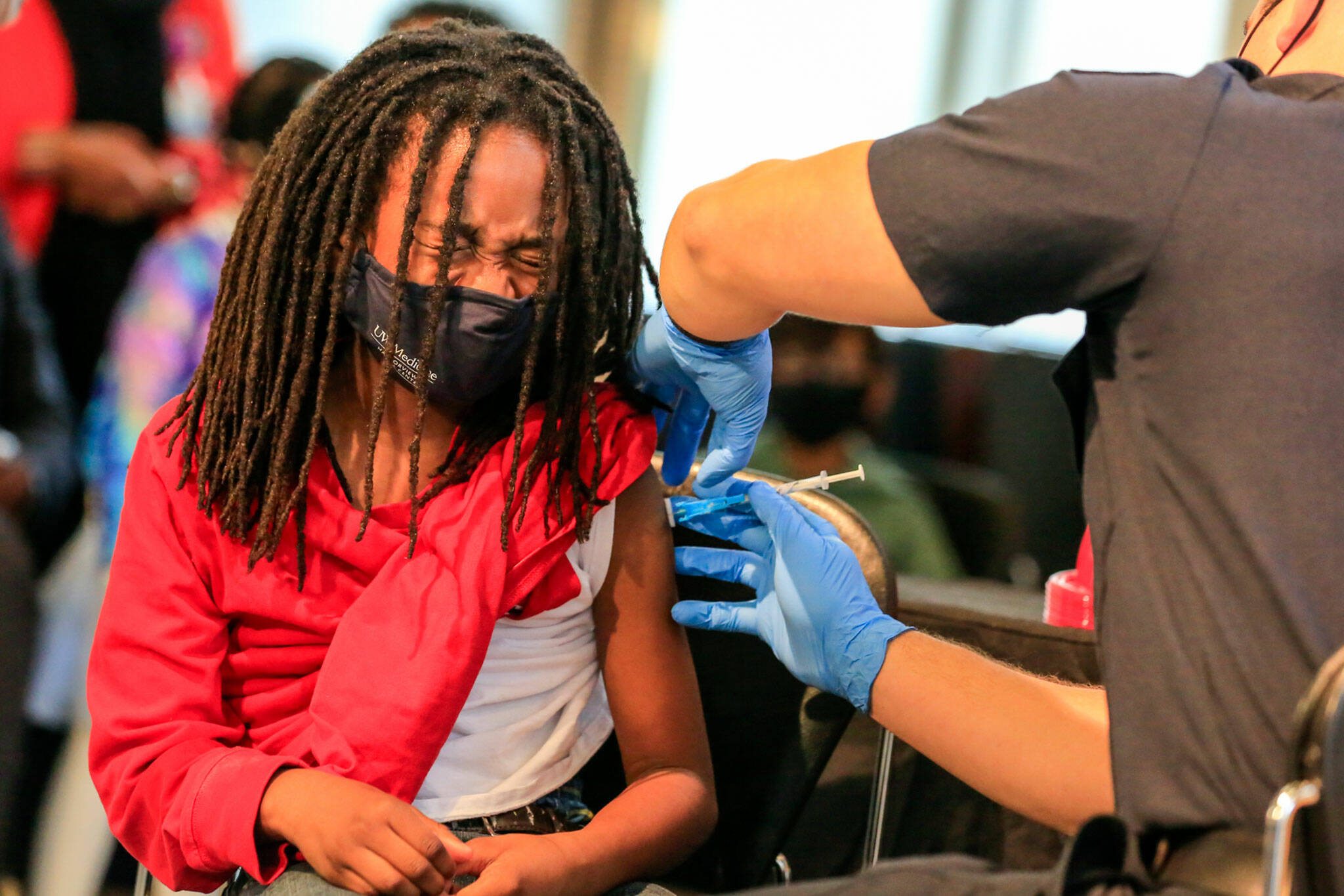 Jeremiah Mack, 9, gets his COVID-19 vaccination Wednesday afternoon at Shoreline Community College. (Kevin Clark / The Herald)