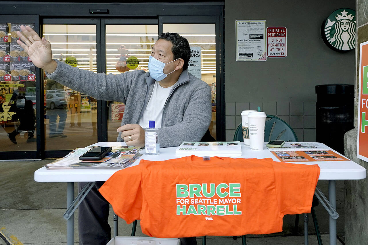 Bruce Harrell, who is running against Lorena Gonzalez in the race for Mayor of Seattle, campaigns Tuesday at a grocery store in South Seattle. (AP Photo/Ted S. Warren)