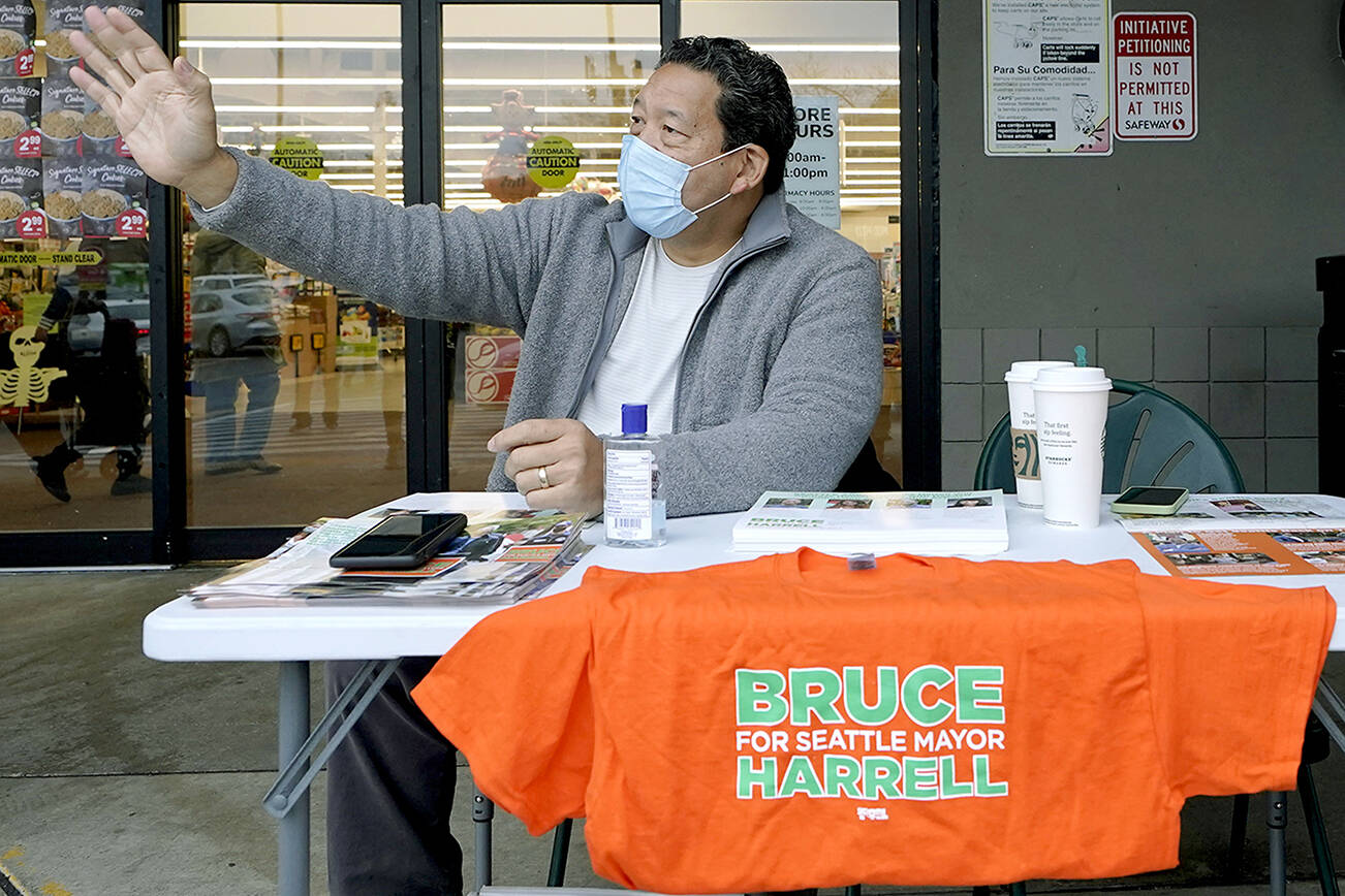 Bruce Harrell, who is running against Lorena Gonzalez in the race for Mayor of Seattle, campaigns Tuesday, Nov. 2, 2021, on Election Day at a grocery store in South Seattle. (AP Photo/Ted S. Warren)