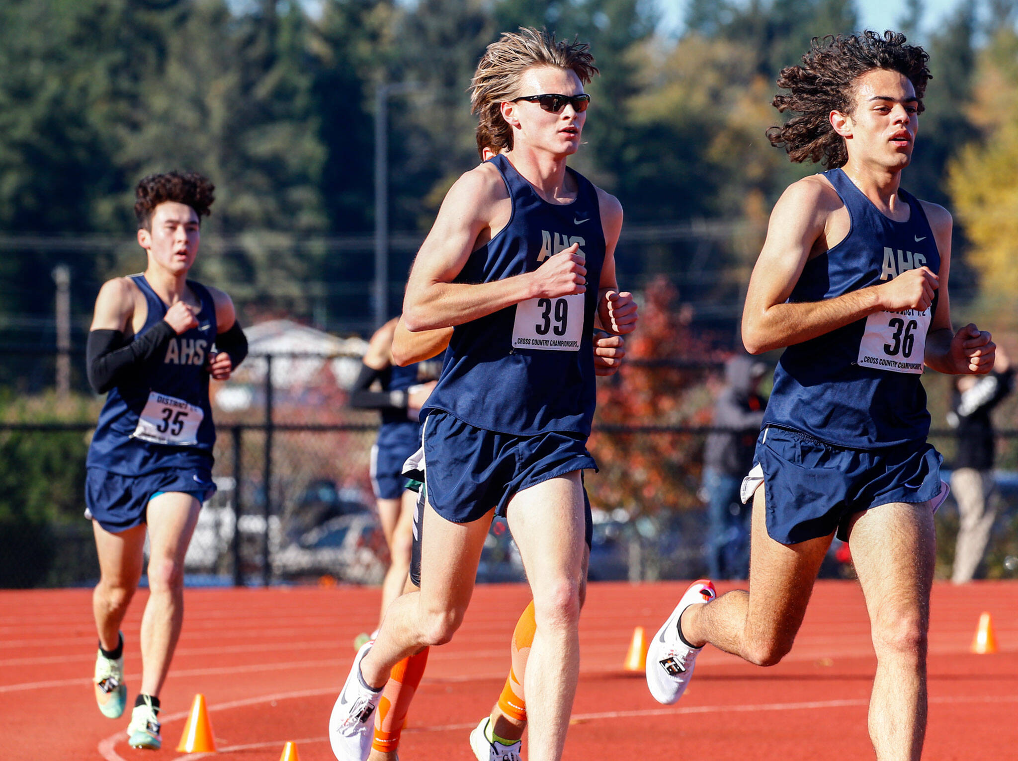 Brandon Moore (36), Aiden Emerson (39) and Kiyoshi Hall (35) have helped lead the Arlington boys cross country team to another dominant season that has them dreaming big heading into Saturday’s state championships. (Kevin Clark / The Herald)