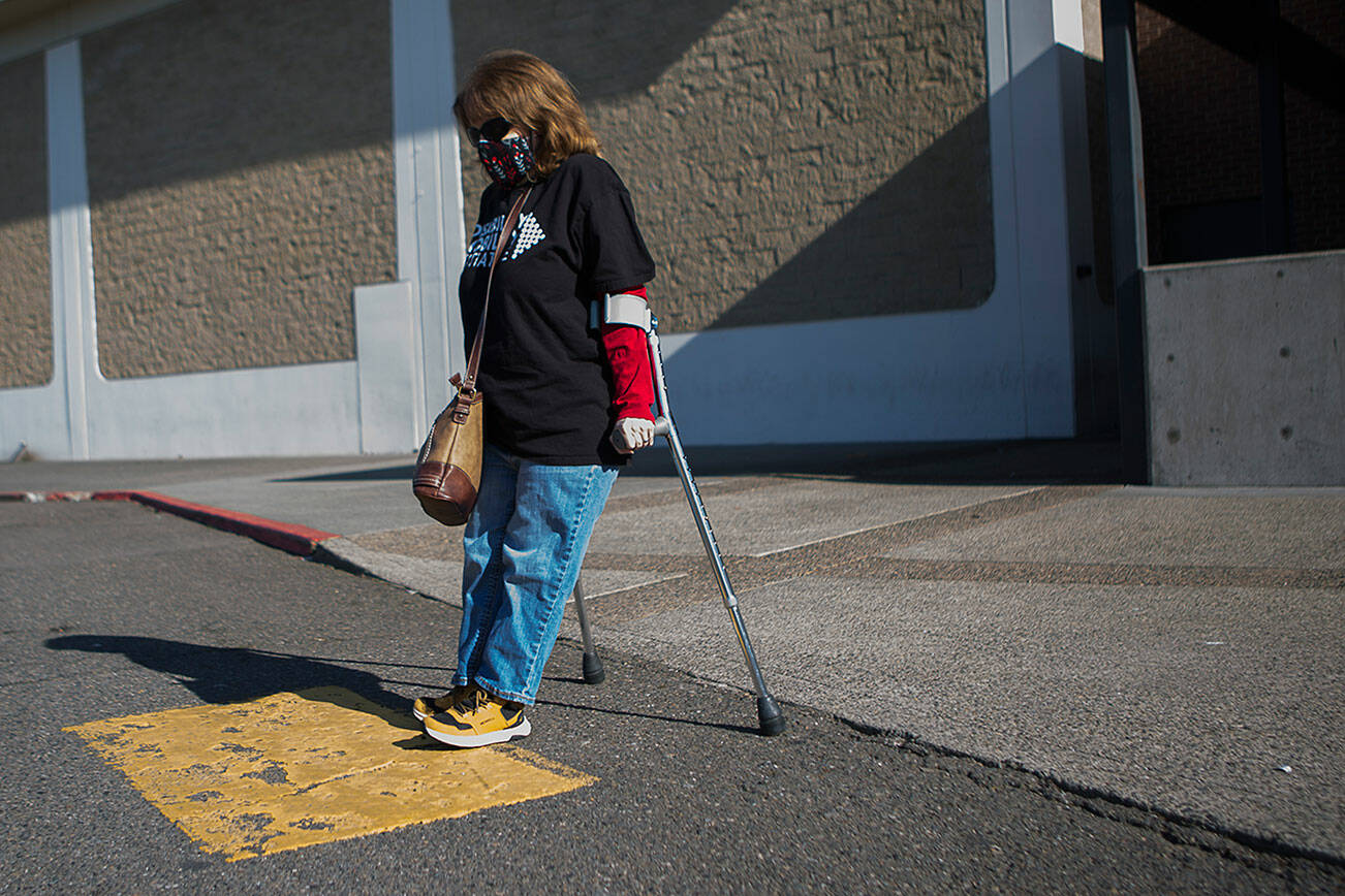 Leigh Spruce navigates from of the ramp cutouts and crosswalks at the Everett Mall on Thursday, March 11, 2021 in Everett, Wa. (Olivia Vanni / The Herald)