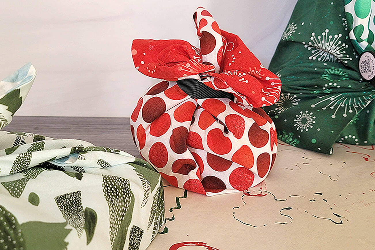 Caption: Green your holiday present wrapping process by choosing reusable fabric and recyclable paper.