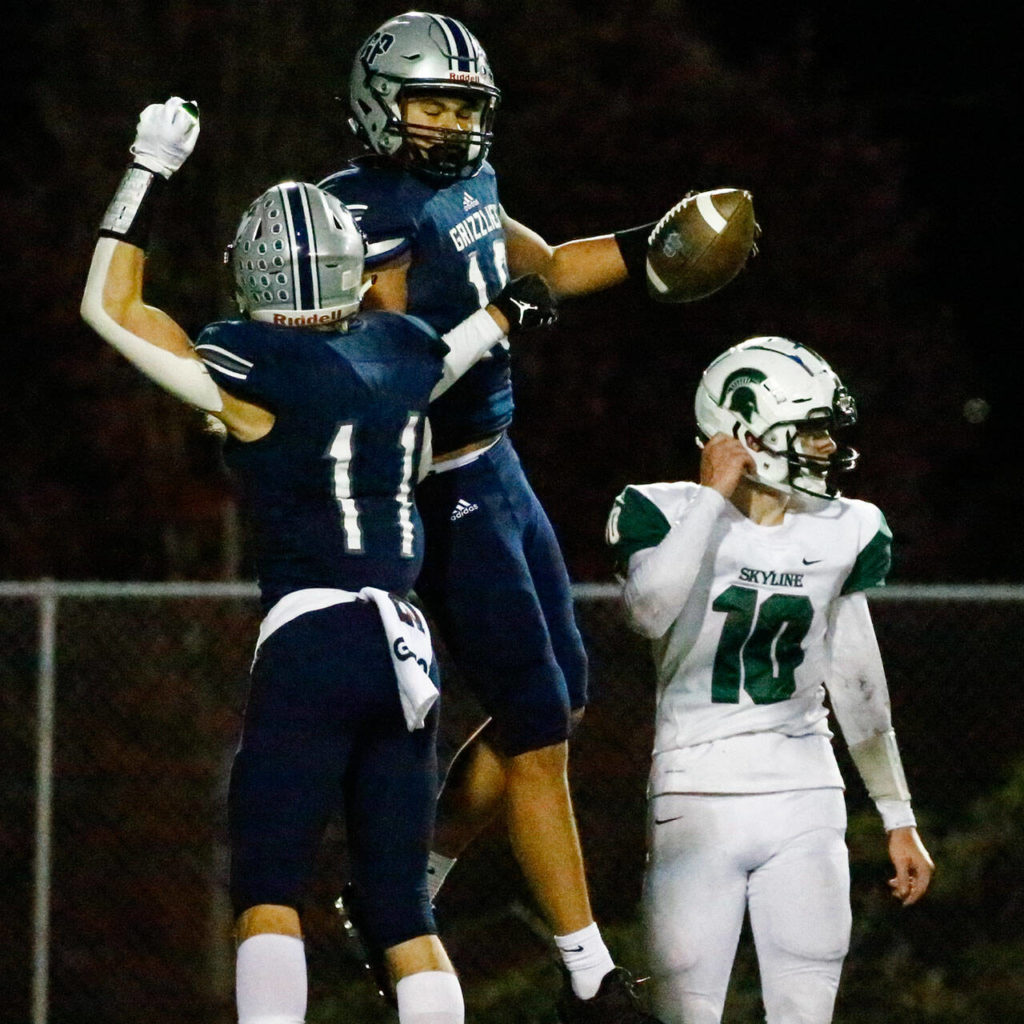 Glacier Peak’s Jadon Claps celebrates teammates’ Torey Watkins touchdown with Skyline’s Carter King Friday night at Veterans’ Memorial Stadium in Snohomish on November 5, 2021. (Kevin Clark / The Herald)
