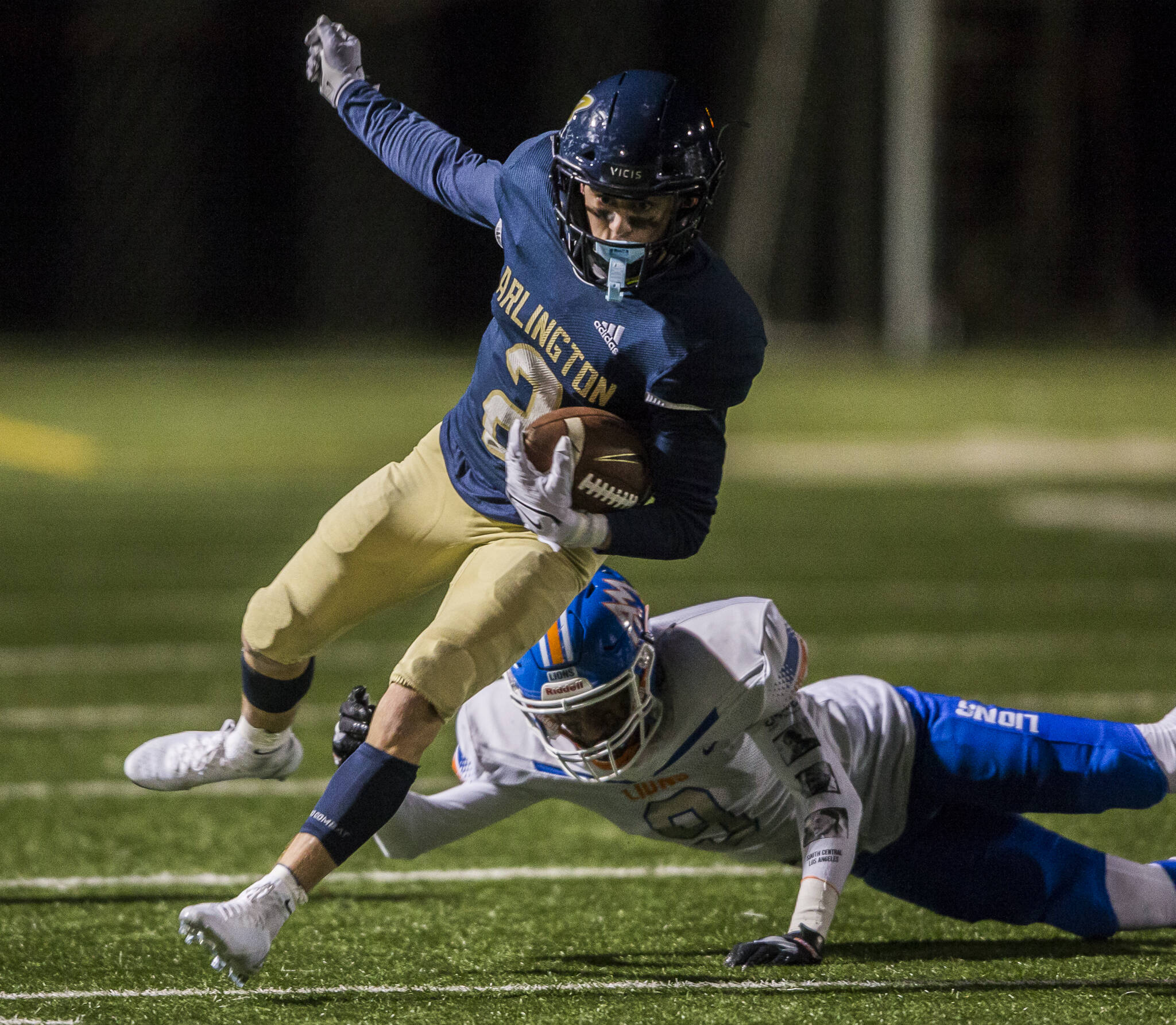 Arlington’s Levi Younger escapes a tackle by Auburn Mountainview’s Elijah January during the game on Friday, Nov. 5, 2021 in Arlington, Wa. (Olivia Vanni / The Herald)