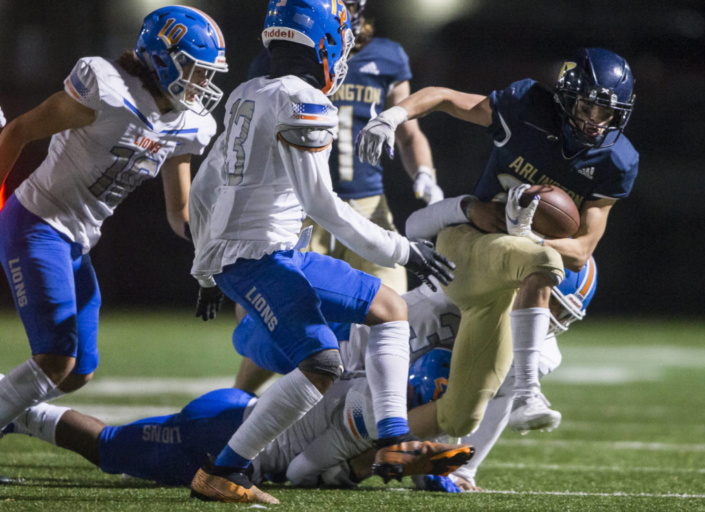 Arlington’s Alex Gonzalez tries to escape a tackle during the game against Auburn Mountainview on Friday, Nov. 5, 2021 in Arlington, Wa. (Olivia Vanni / The Herald)
