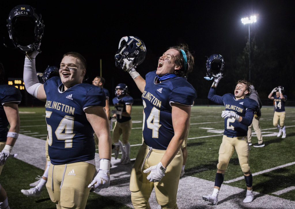 Arlington’s Mason Marsh yells with his teammates after beating Auburn Mountainview to advance to the playoffs on Friday, Nov. 5, 2021 in Arlington, Wa. (Olivia Vanni / The Herald)
