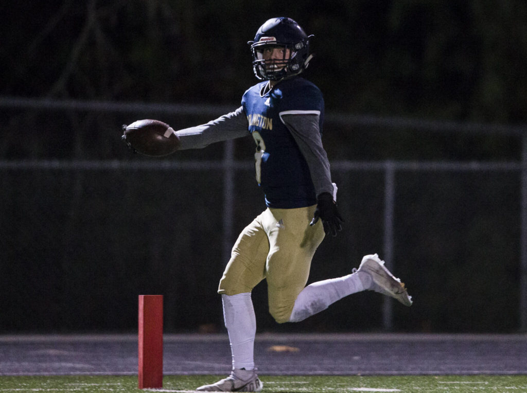 Arlington’s Ethan Martin runs the ball into the end zone after picking up a fumble by Auburn Mountianview during the game on Friday, Nov. 5, 2021 in Arlington, Wa. (Olivia Vanni / The Herald)
