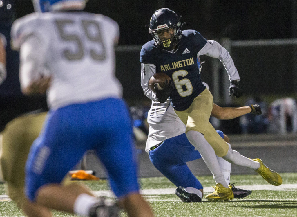 Arlington’s Elijah Jackson runs the ball after an interception during the game against Auburn Mountainview on Friday, Nov. 5, 2021 in Arlington, Wa. (Olivia Vanni / The Herald)
