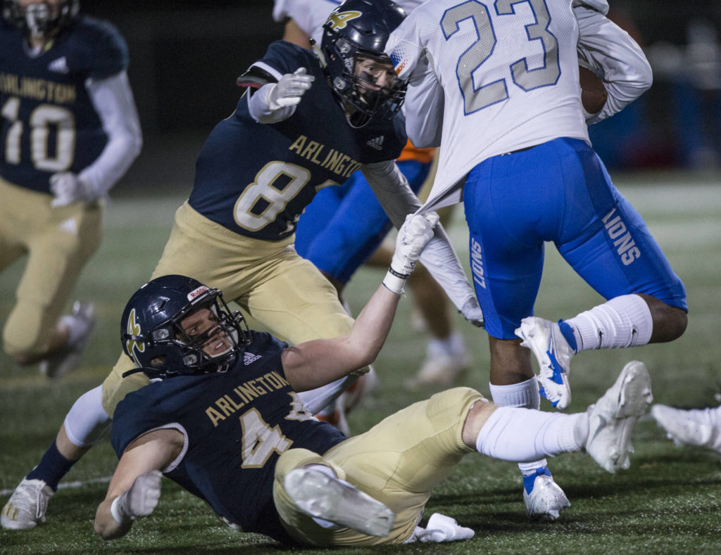 Arlington’s Spencer Fischer grabs onto Auburn Mountainview’s Joeray Kilgore jersey during the game against Auburn Mountainview on Friday, Nov. 5, 2021 in Arlington, Wa. (Olivia Vanni / The Herald)
