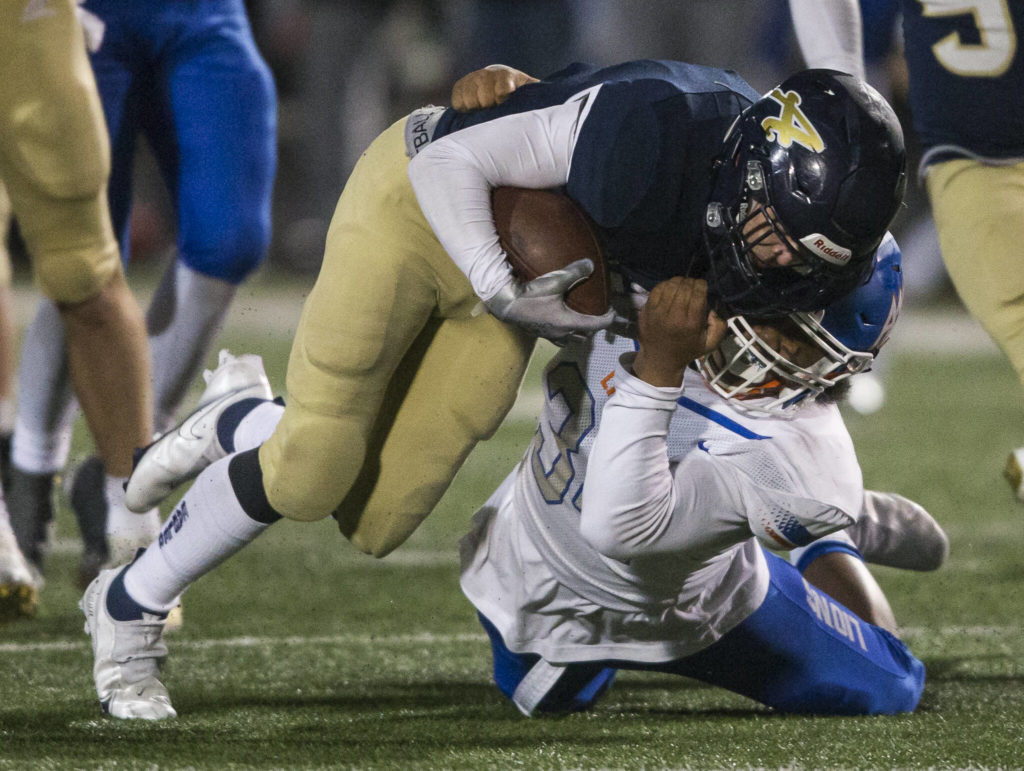 Arlington’s RJ Gese is tackled during the game against Auburn Mountainview on Friday, Nov. 5, 2021 in Arlington, Wa. (Olivia Vanni / The Herald)
