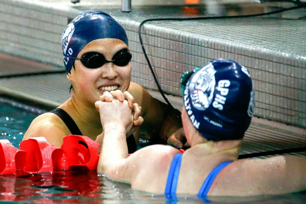 Glacier Peak’s Lily Lao, left, and Alexa Sullivan celebrate a one two finish in the 200 yard freestyle Saturday afternoon during the 4A Girls District Championships at the Snohomish Aquatic Center on November 6, 2021. (Kevin Clark / The Herald)

