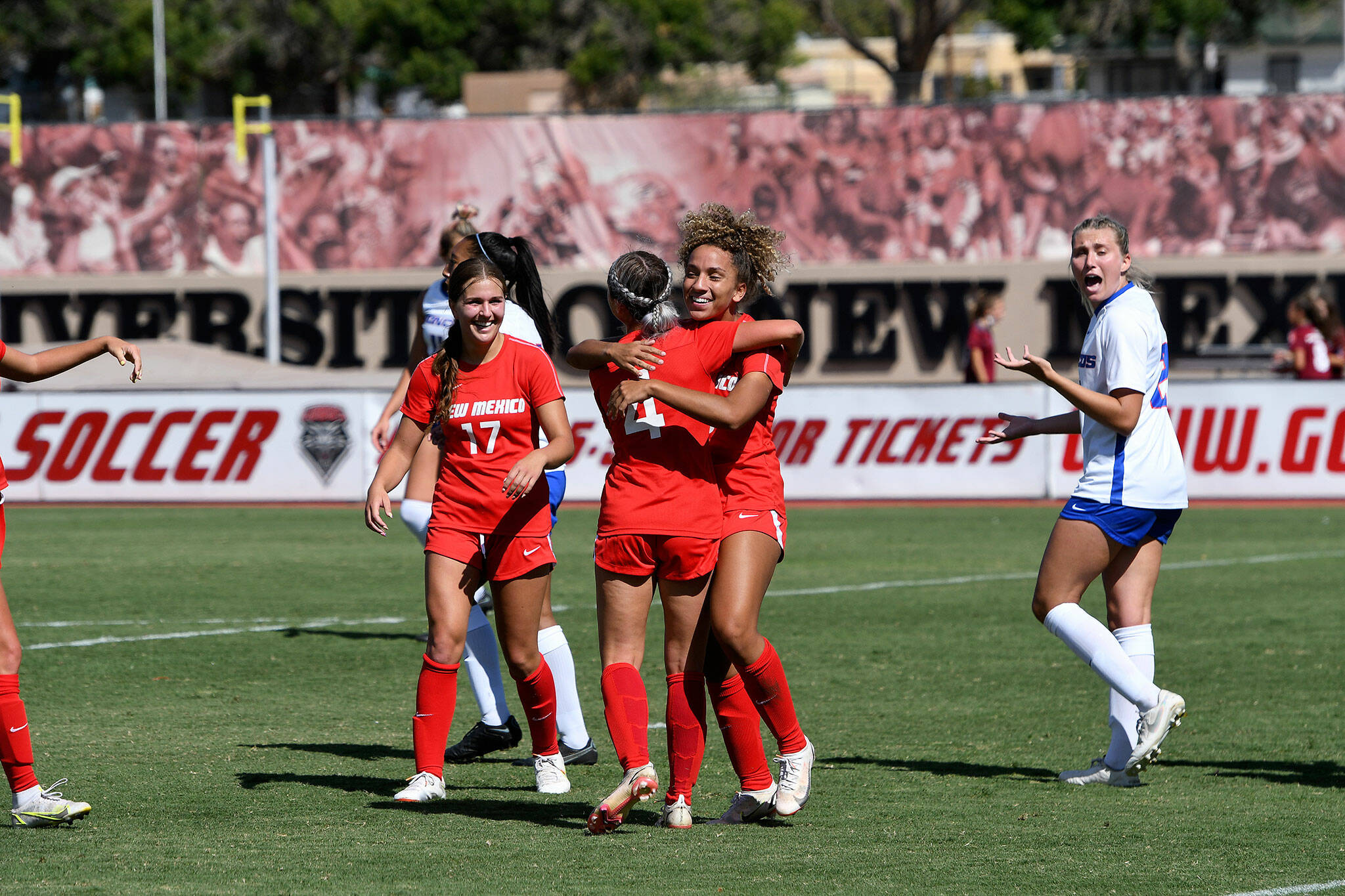 New Mexico women’s soccer player Jadyn Edwards (rear), a Jackson High School graduate, hugs a teammate during a game earlier this season. (University of New Mexico photo)