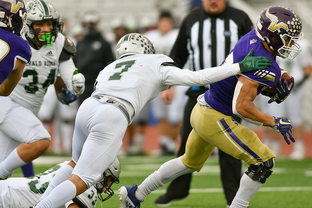 Lake Stevens running back Jayden Limar (right) eludes a tackle on his way to a touchdown during a playoff game against Emerald Ridge on Saturday, Nov. 6, 2021, at Lake Stevens High School. (John Gardner/Pro Action Image)